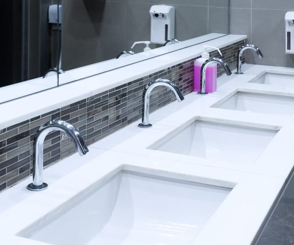 Toilet sink interior of public toilet with of washing hands and mirror